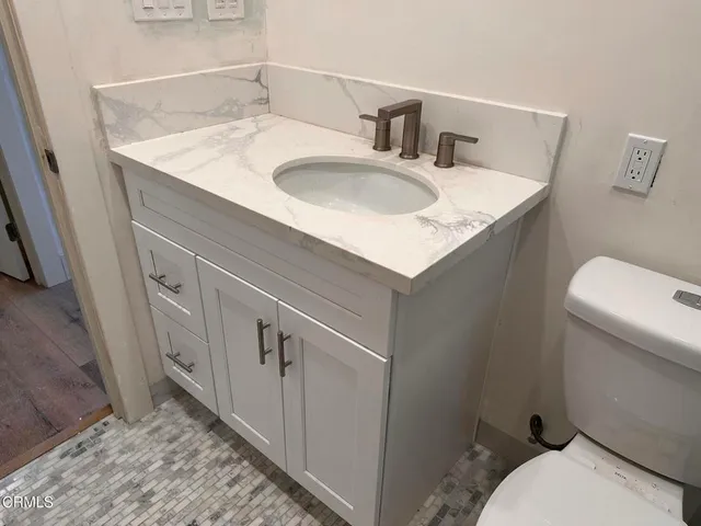 a bathroom with a sink toilet and vanity