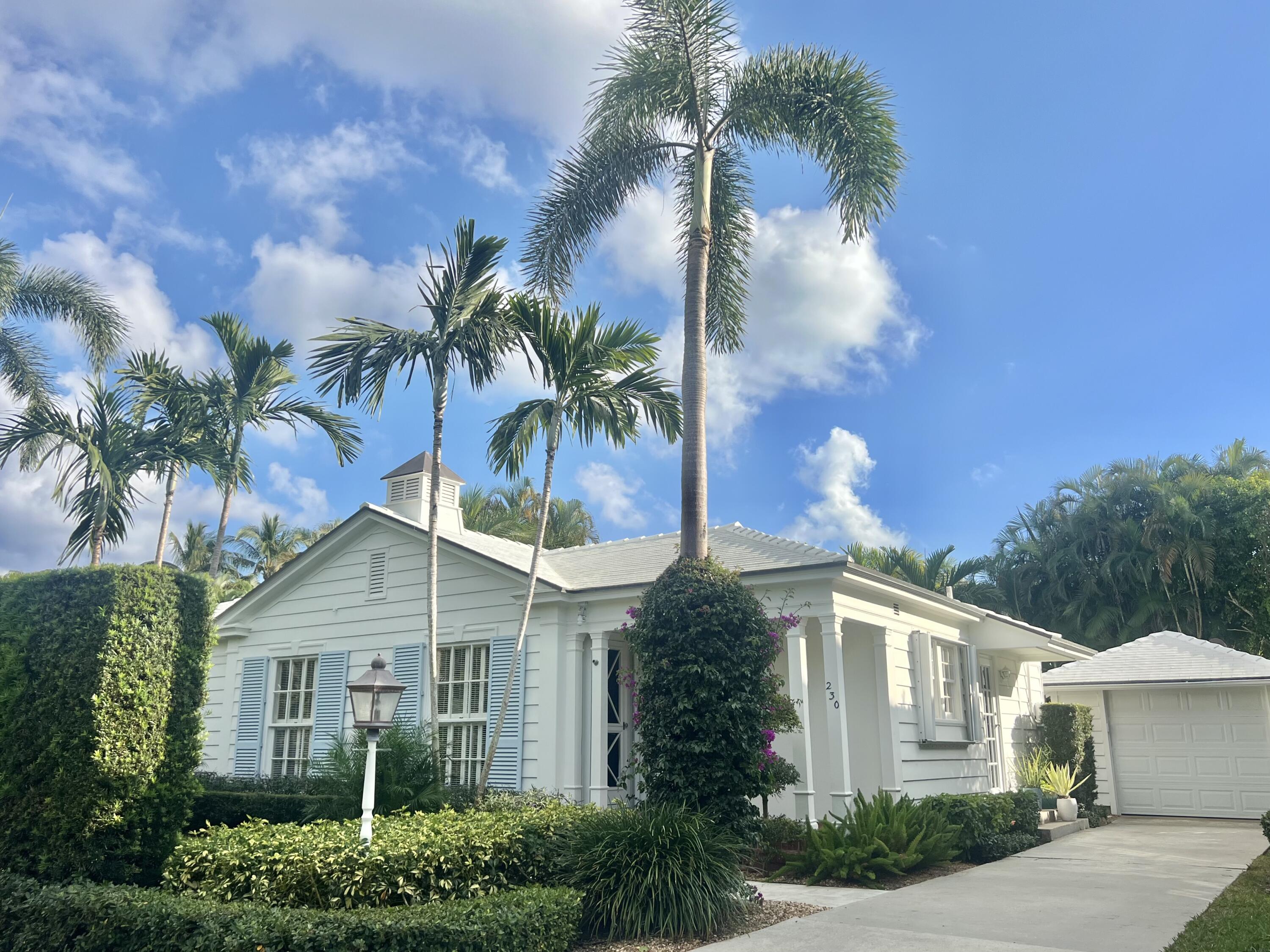a view of house with palm tree in front of it