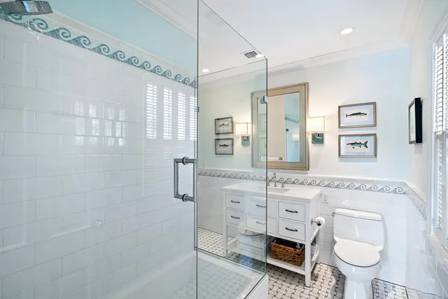 a spacious bathroom with a granite countertop toilet sink and mirror