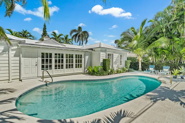 a view of a house with a backyard and plants