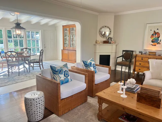 a living room with furniture a fireplace and a large window