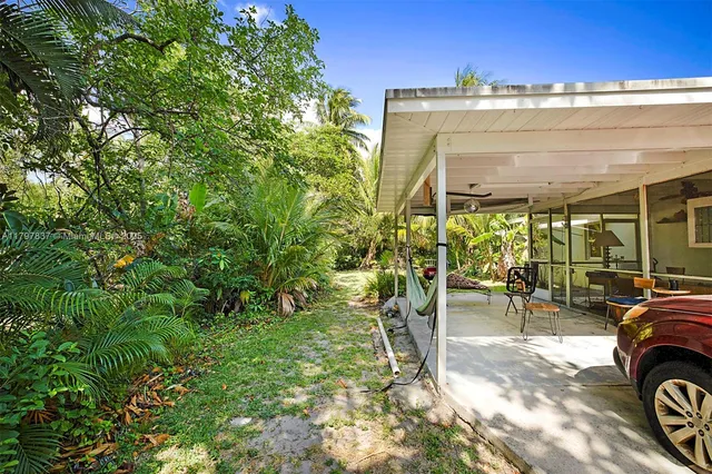a view of a chairs and table in the patio