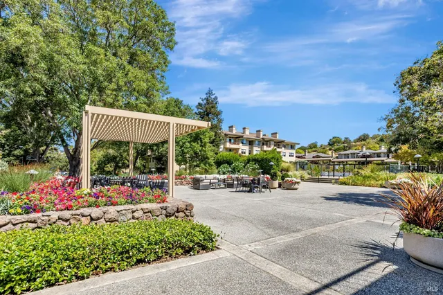 a view of a patio with a table and chairs and potted plants