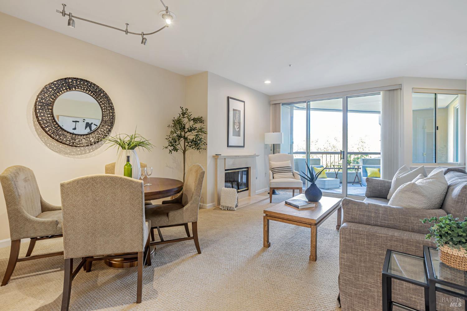 300 Deer Valley Road, Unit 3P San Rafael, CA 94903 - Photo 5 of 23 a living room with furniture a fireplace and a floor to ceiling window