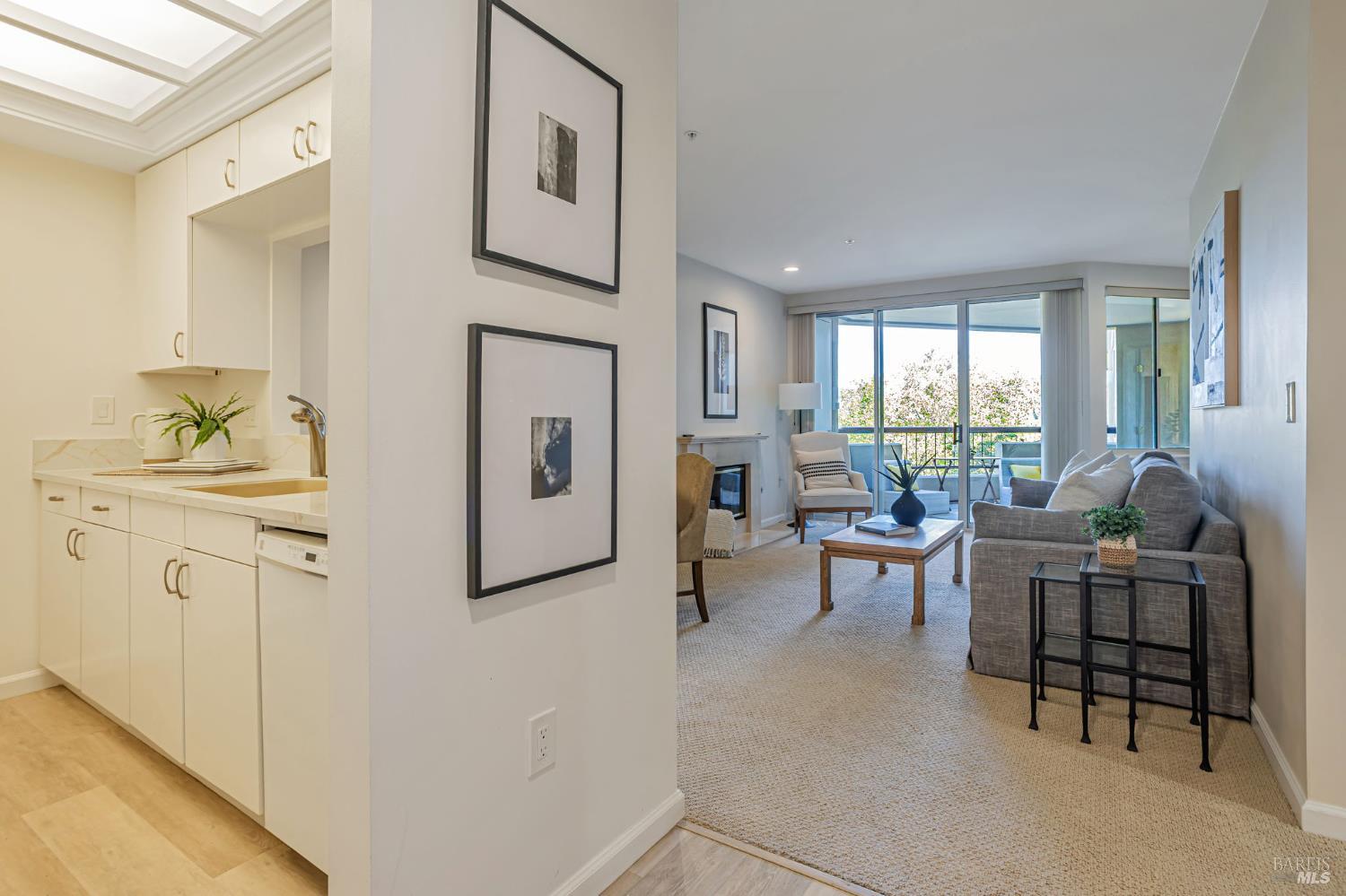 300 Deer Valley Road, Unit 3P San Rafael, CA 94903 - Photo 9 of 23 a living room with furniture a fireplace and a table