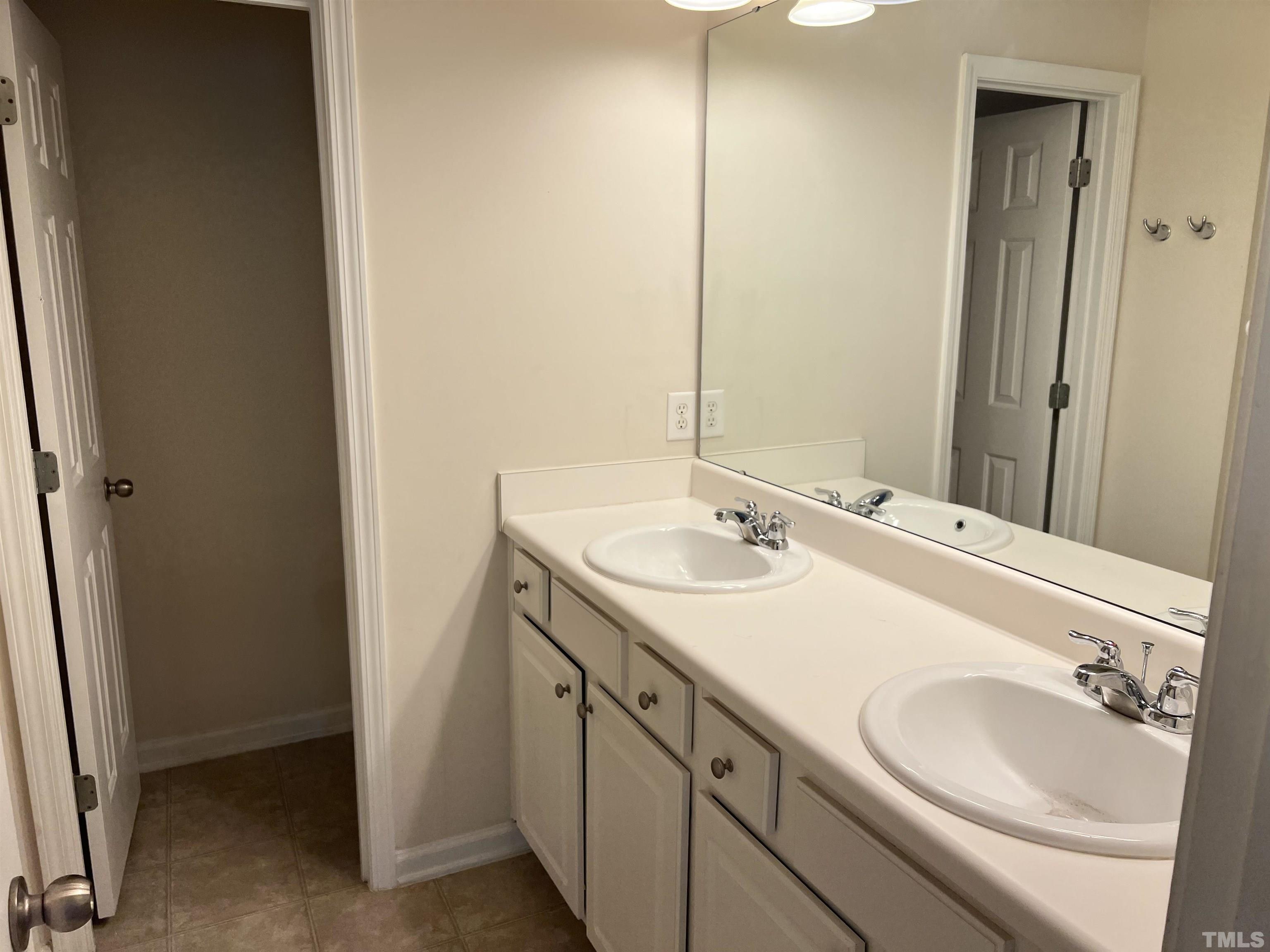 7110 Racine Way Raleigh, NC 27615 - Photo 15 of 19 a bathroom with a sink and a mirror