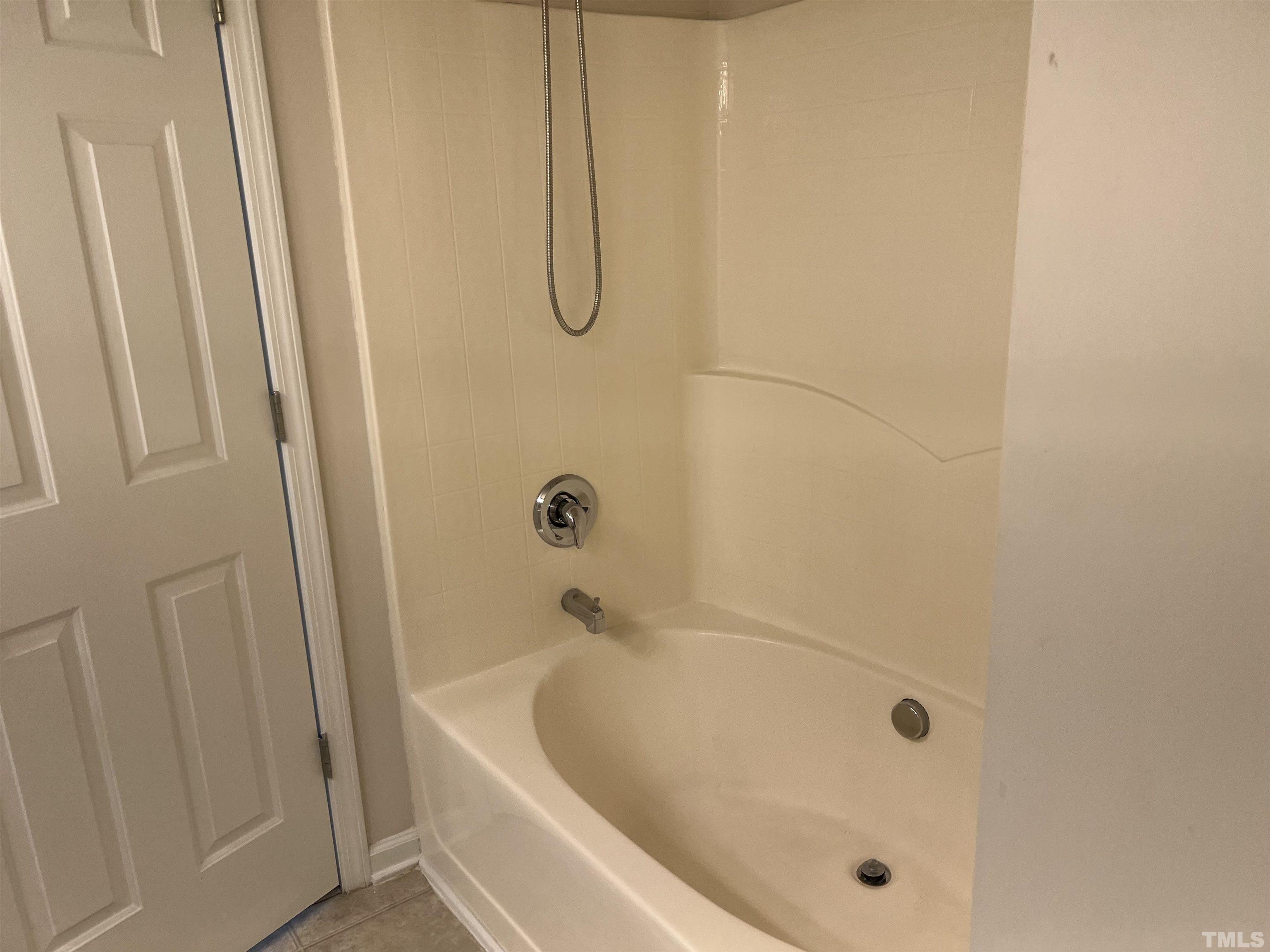 7110 Racine Way Raleigh, NC 27615 - Photo 16 of 19 a bathroom with a tub
