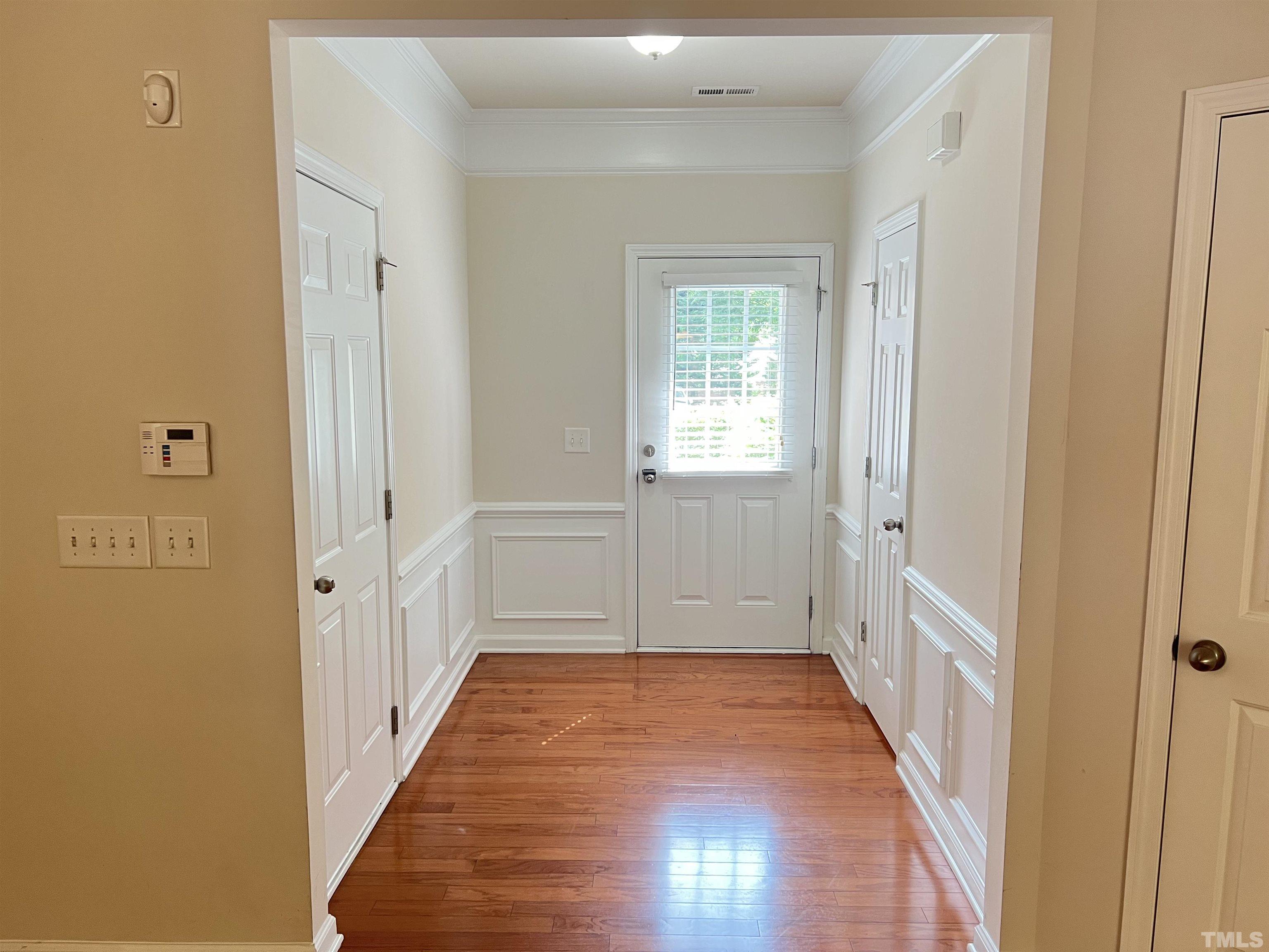 7110 Racine Way Raleigh, NC 27615 - Photo 2 of 19 a view of a hallway with wooden floor and a bathroom