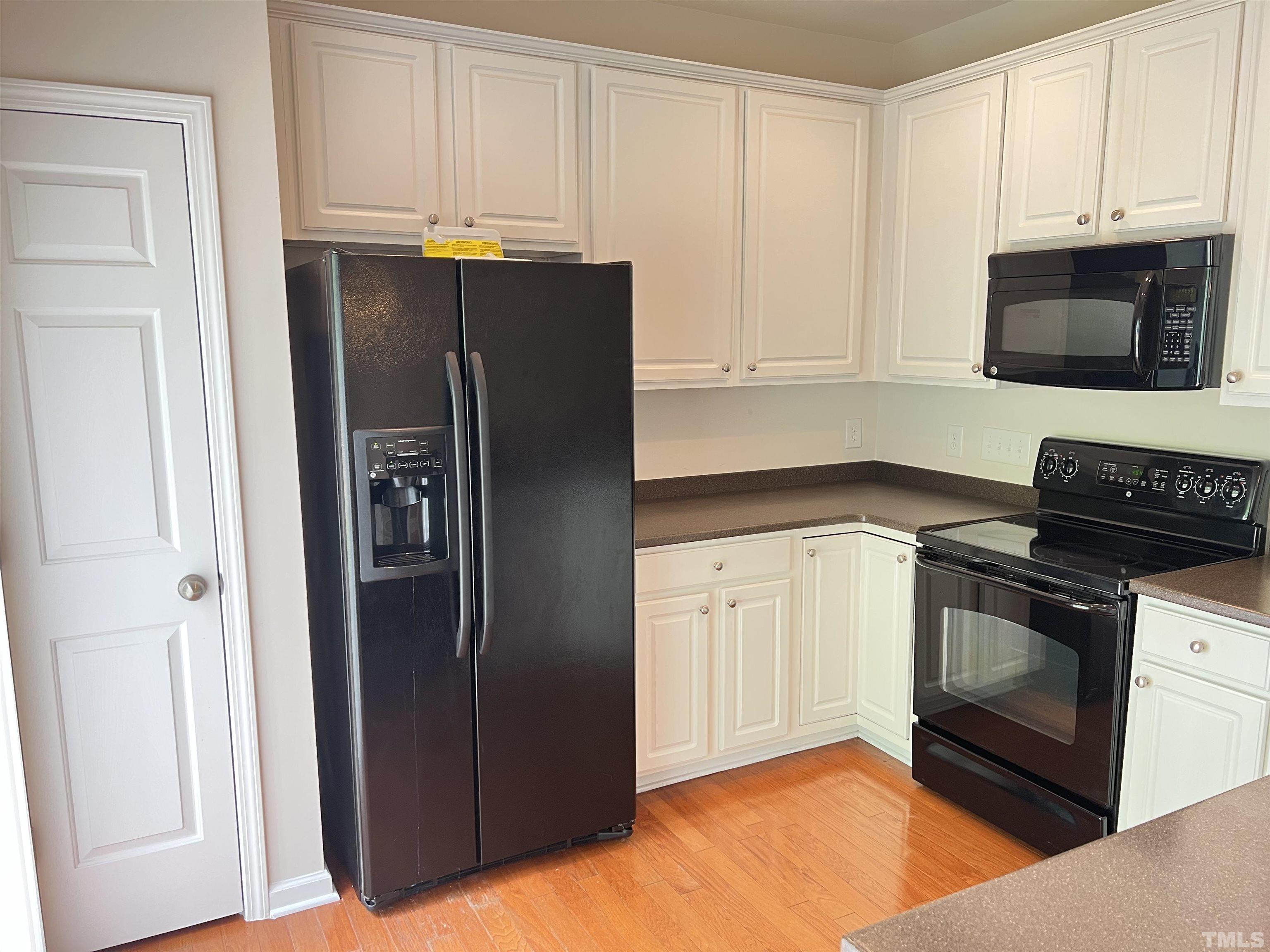 7110 Racine Way Raleigh, NC 27615 - Photo 6 of 19 a kitchen with stainless steel appliances granite countertop a refrigerator stove and microwave
