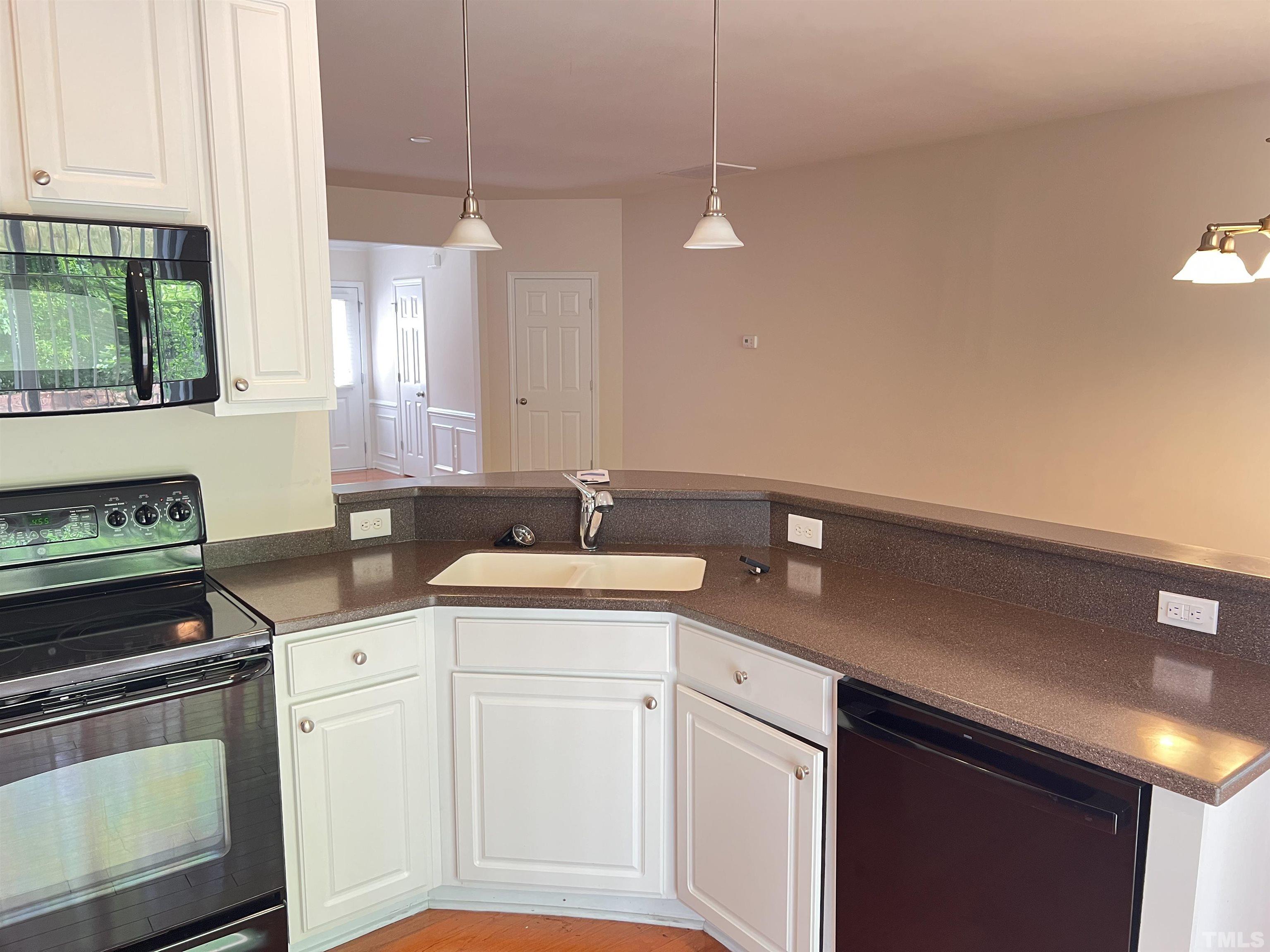 7110 Racine Way Raleigh, NC 27615 - Photo 7 of 19 a kitchen with a sink stove and cabinets