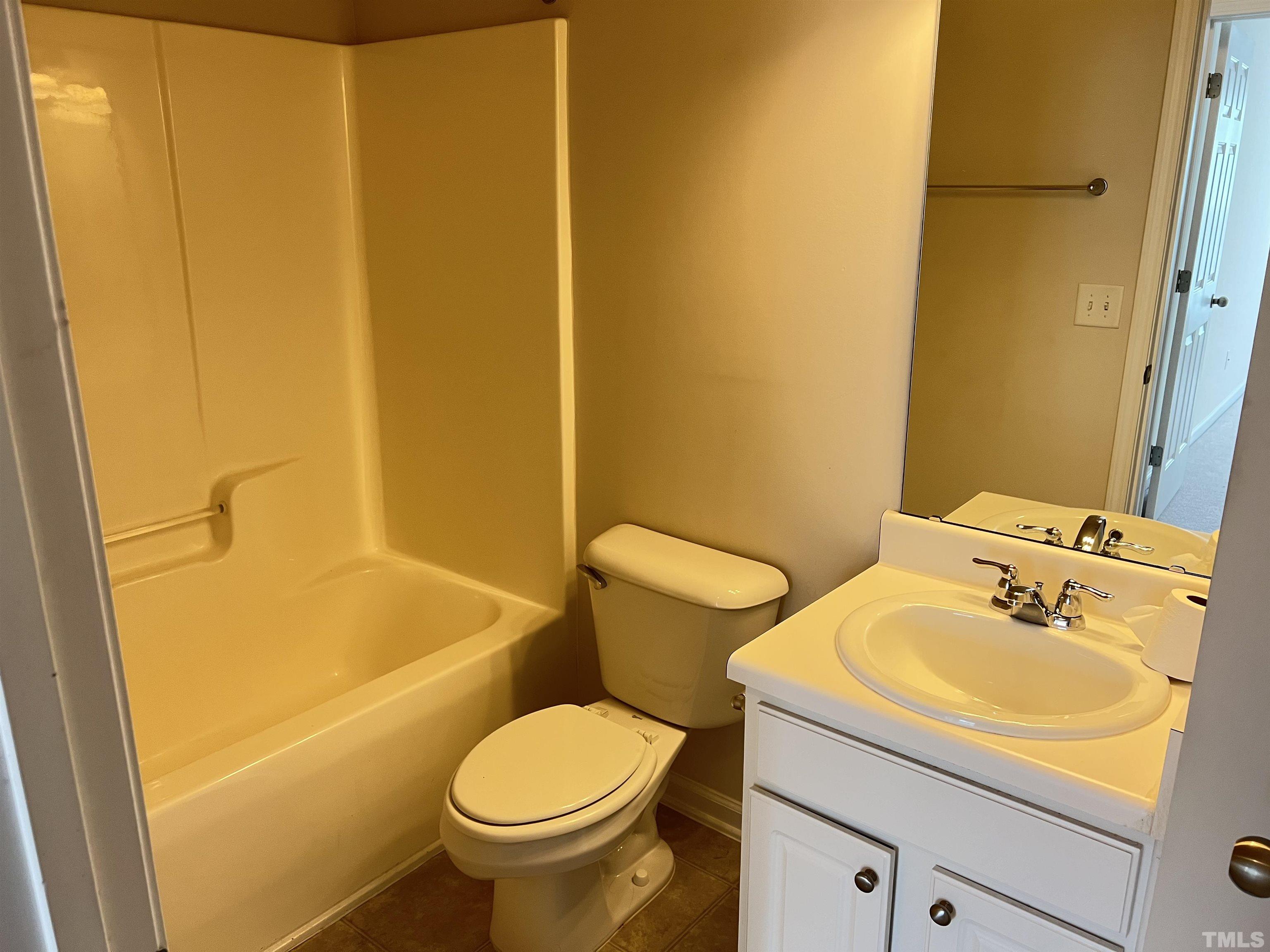 7110 Racine Way Raleigh, NC 27615 - Photo 9 of 19 a bathroom with a sink and a toilet