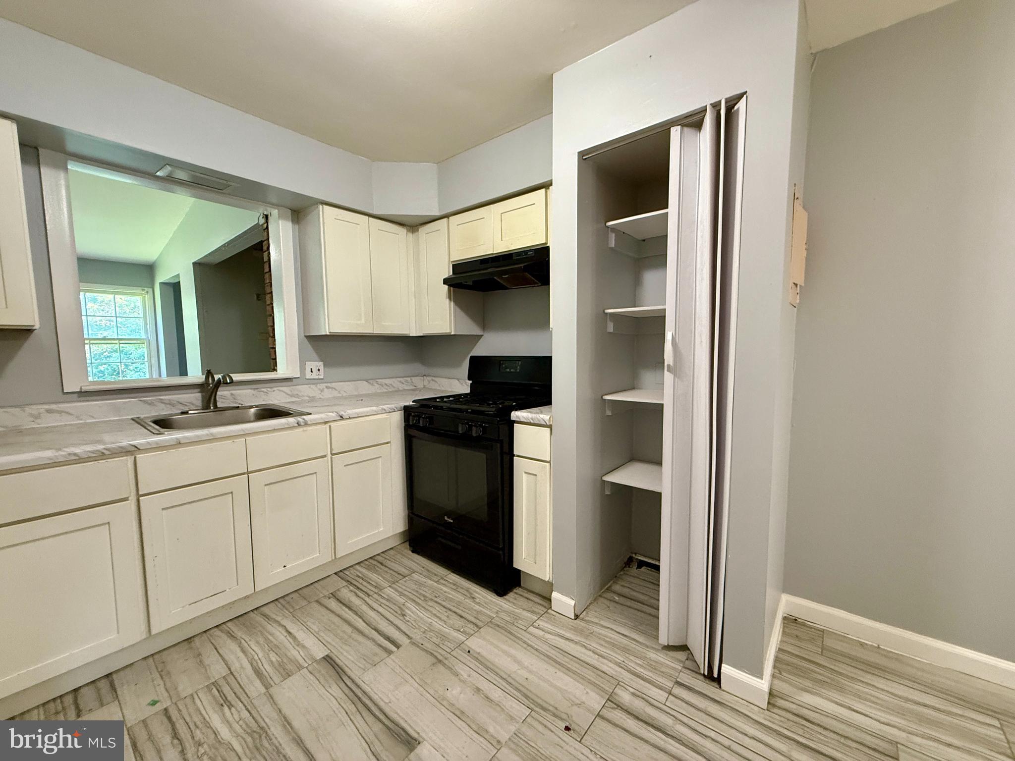 701 Harrison Street Riverside, NJ 08075 - Photo 12 of 26 a kitchen with a refrigerator and a sink