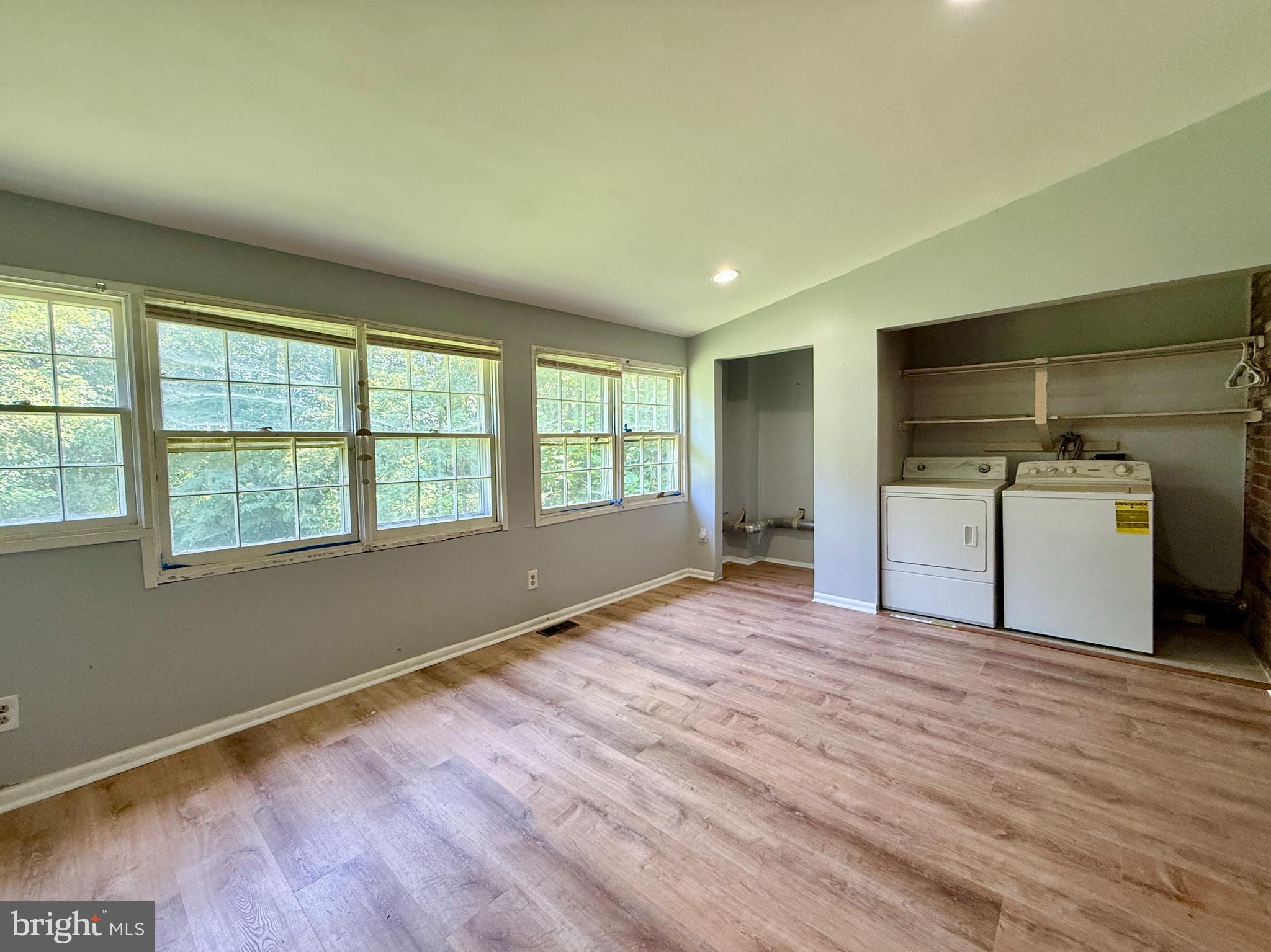 701 Harrison Street Riverside, NJ 08075 - Photo 13 of 26 a view of empty room with kitchen and wooden floor