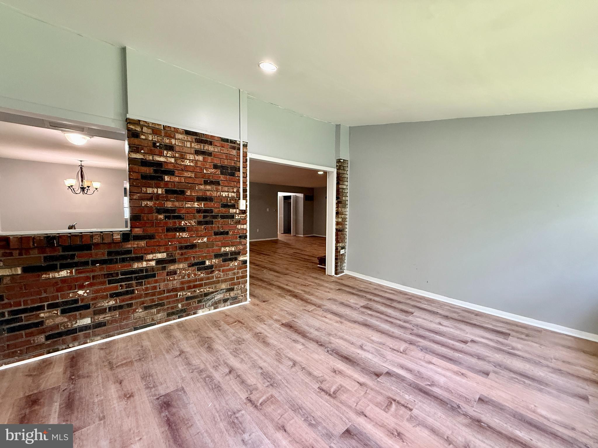 701 Harrison Street Riverside, NJ 08075 - Photo 15 of 26 a view of an empty room with wooden floor and staircase
