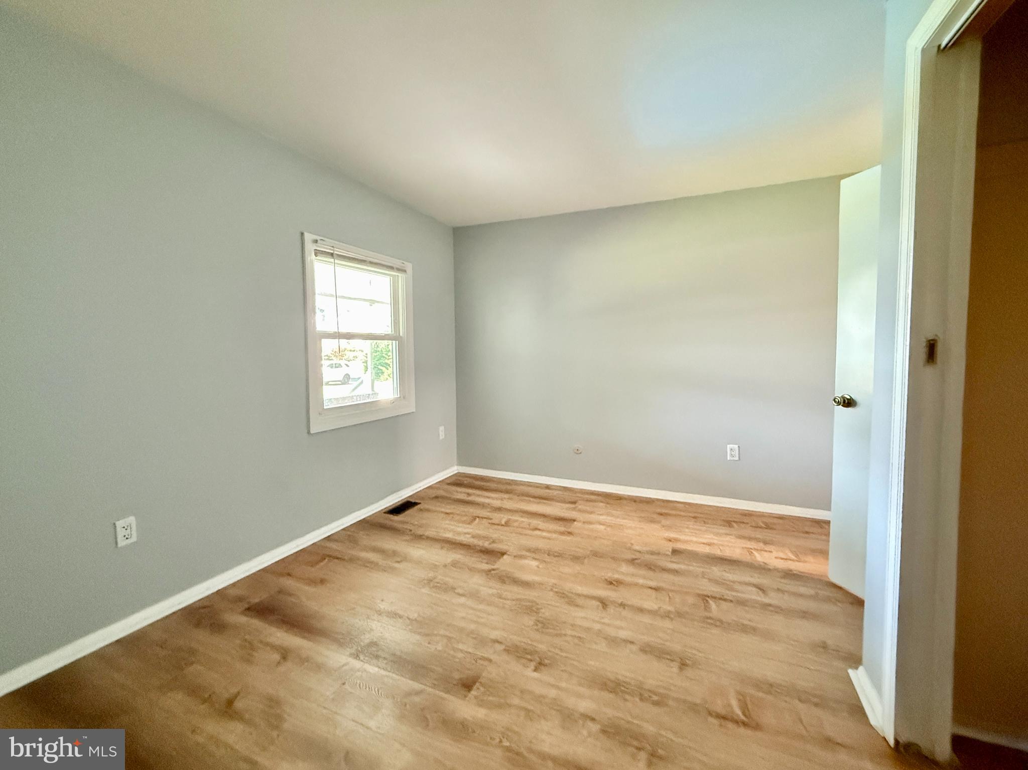 701 Harrison Street Riverside, NJ 08075 - Photo 21 of 26 a view of an empty room with wooden floor and a window