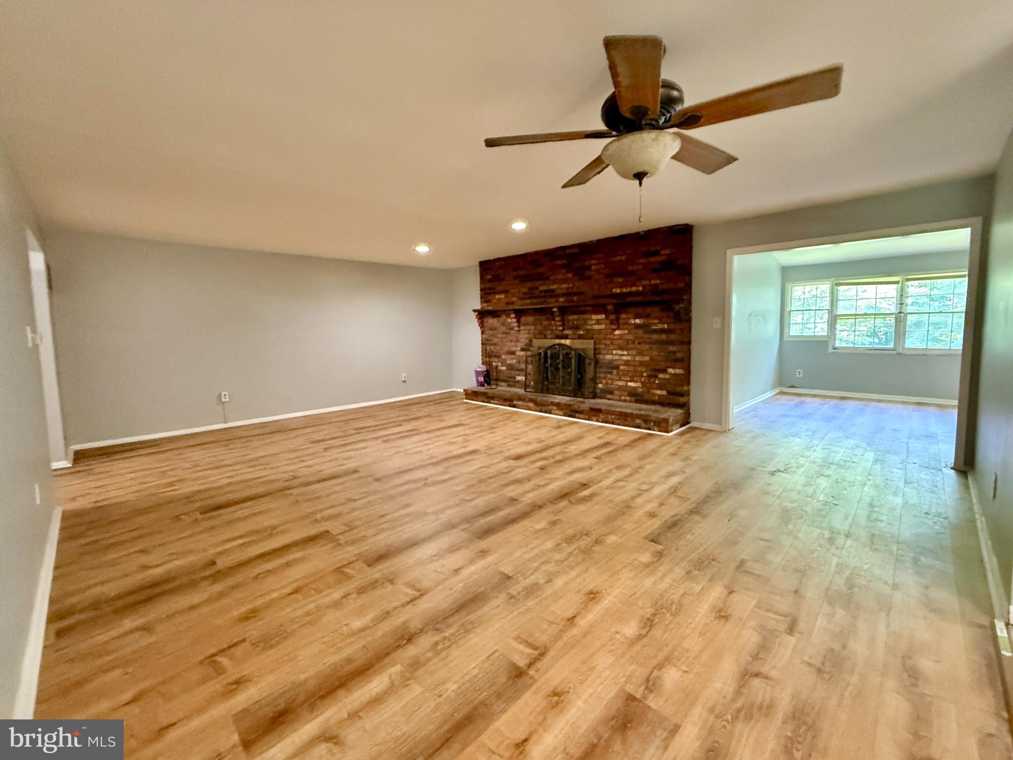 701 Harrison Street Riverside, NJ 08075 - Photo 6 of 26 a view of an empty room with a fireplace and a window