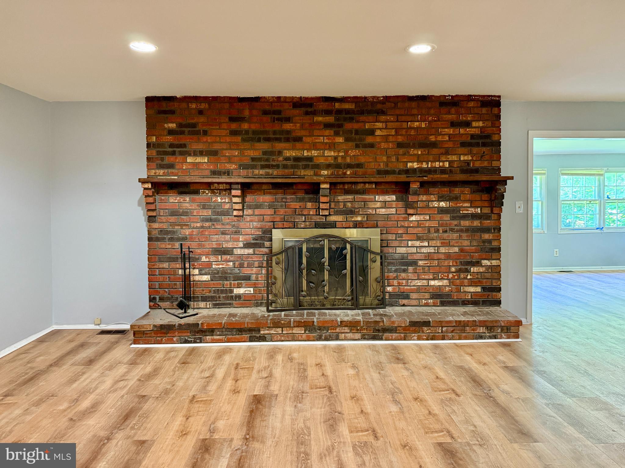 701 Harrison Street Riverside, NJ 08075 - Photo 7 of 26 a view of a livingroom with an empty space and wooden floor