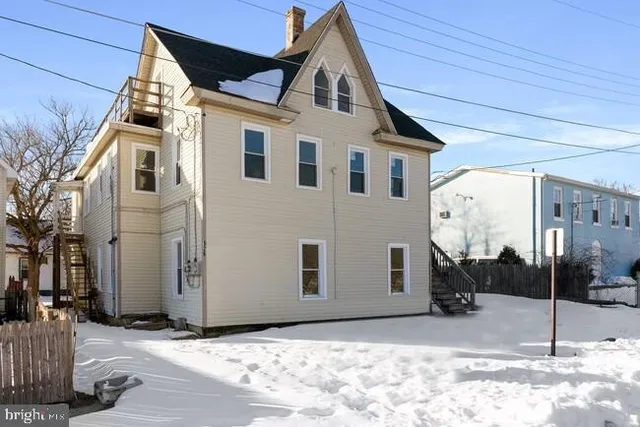 a view of a white house with a yard