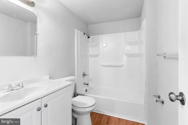 a bathroom with a sink toilet a mirror and shower