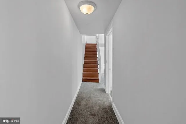 a view of a hallway with stairs