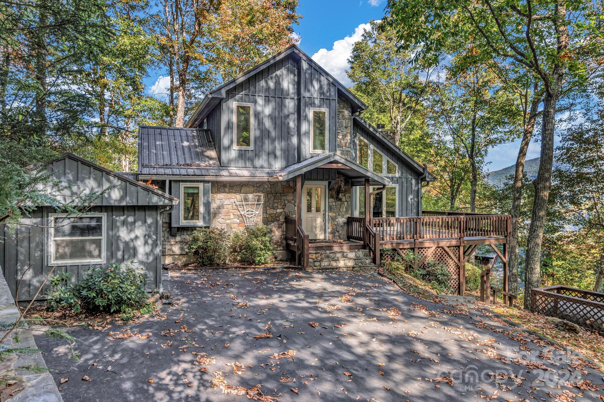 122 Kings Ridge Road Maggie Valley, NC 28751 - Photo 1 of 47 a front view of a house with garden