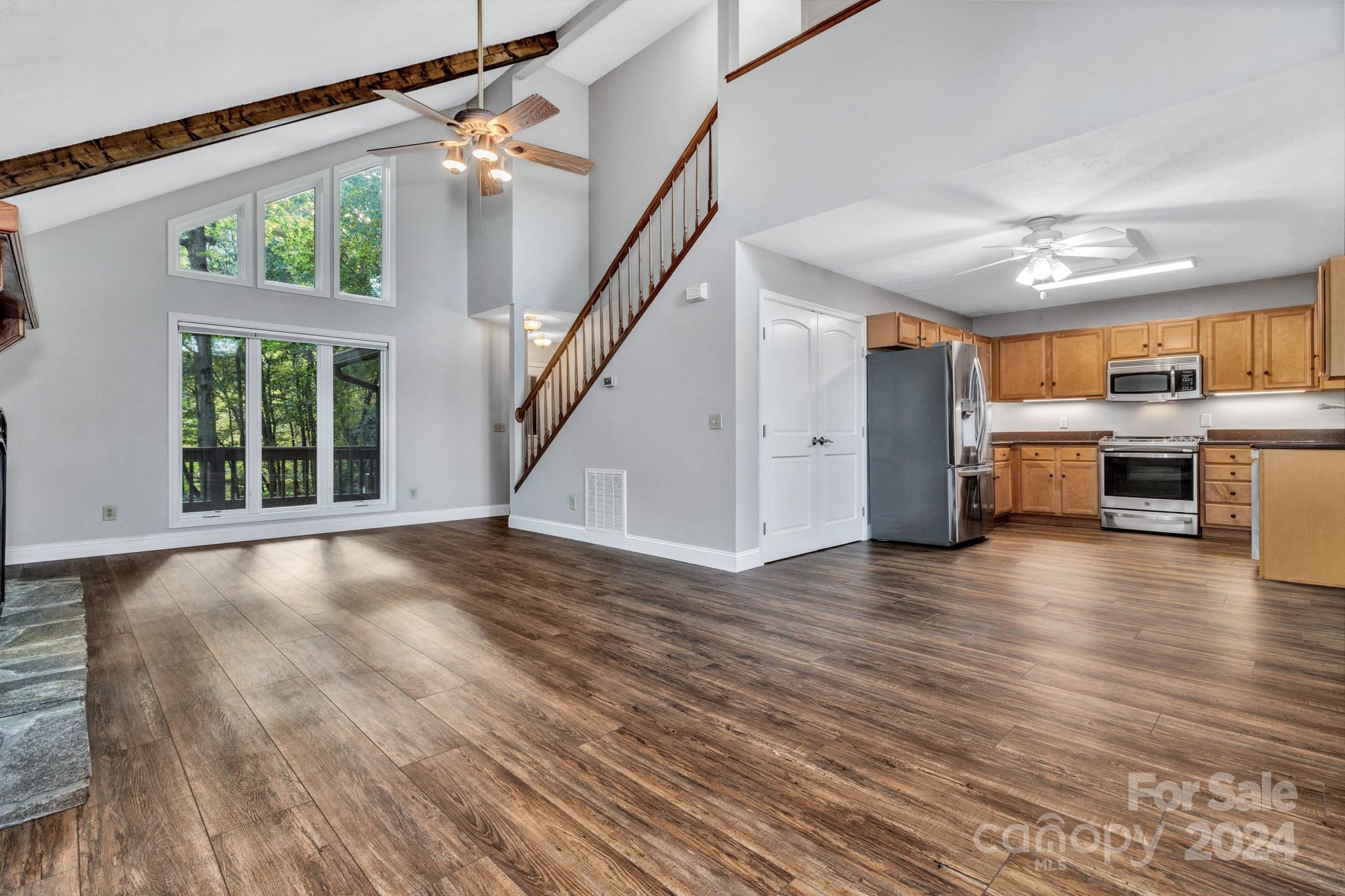 122 Kings Ridge Road Maggie Valley, NC 28751 - Photo 12 of 47 a view of a livingroom with furniture staircase and kitchen view
