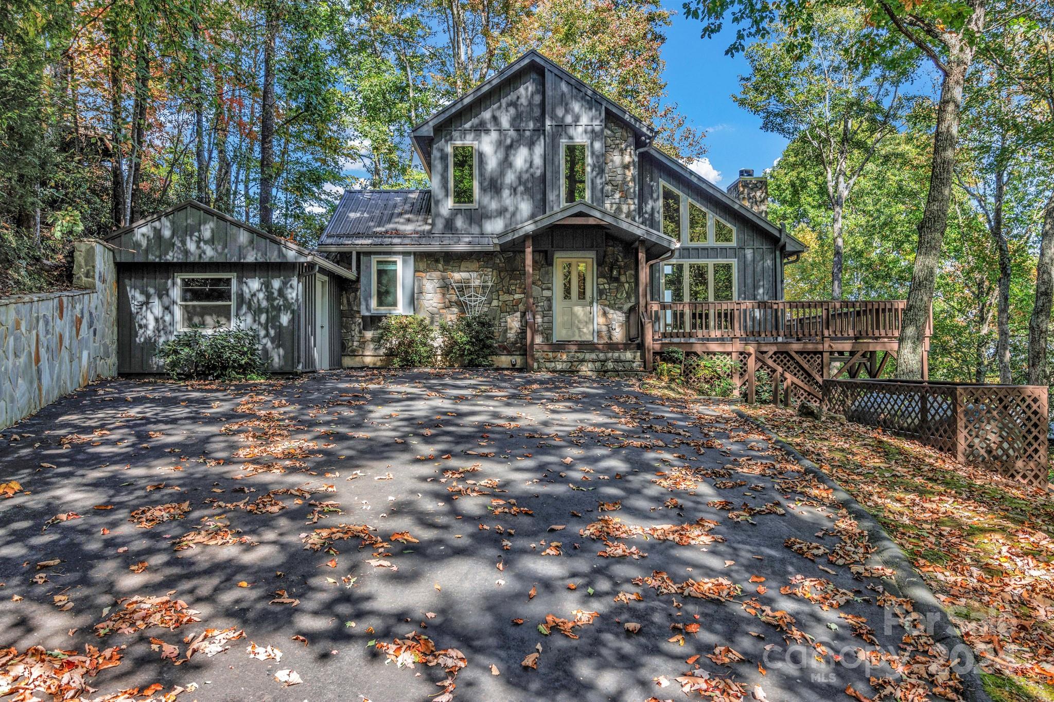 122 Kings Ridge Road Maggie Valley, NC 28751 - Photo 2 of 47 a front view of a house with garden