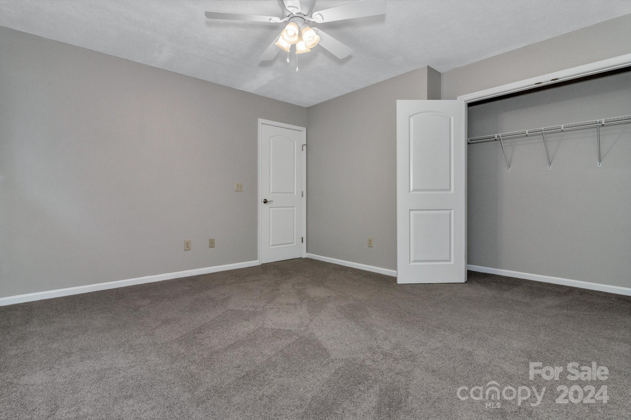 122 Kings Ridge Road Maggie Valley, NC 28751 - Photo 35 of 47 an empty room with chandelier fan