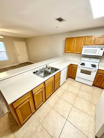 a kitchen with a cabinets and white appliances