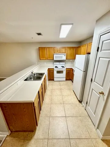 a kitchen with a stove a sink and a refrigerator
