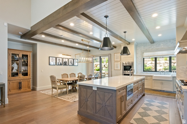 3 Carriagewood Cove, Unit 1088 Sandy, UT 84092 - Photo 18 of 79 Spacious kitchen and dining area featuring wood-finish flooring, a coffered ceiling with exposed beams, and recessed lighting