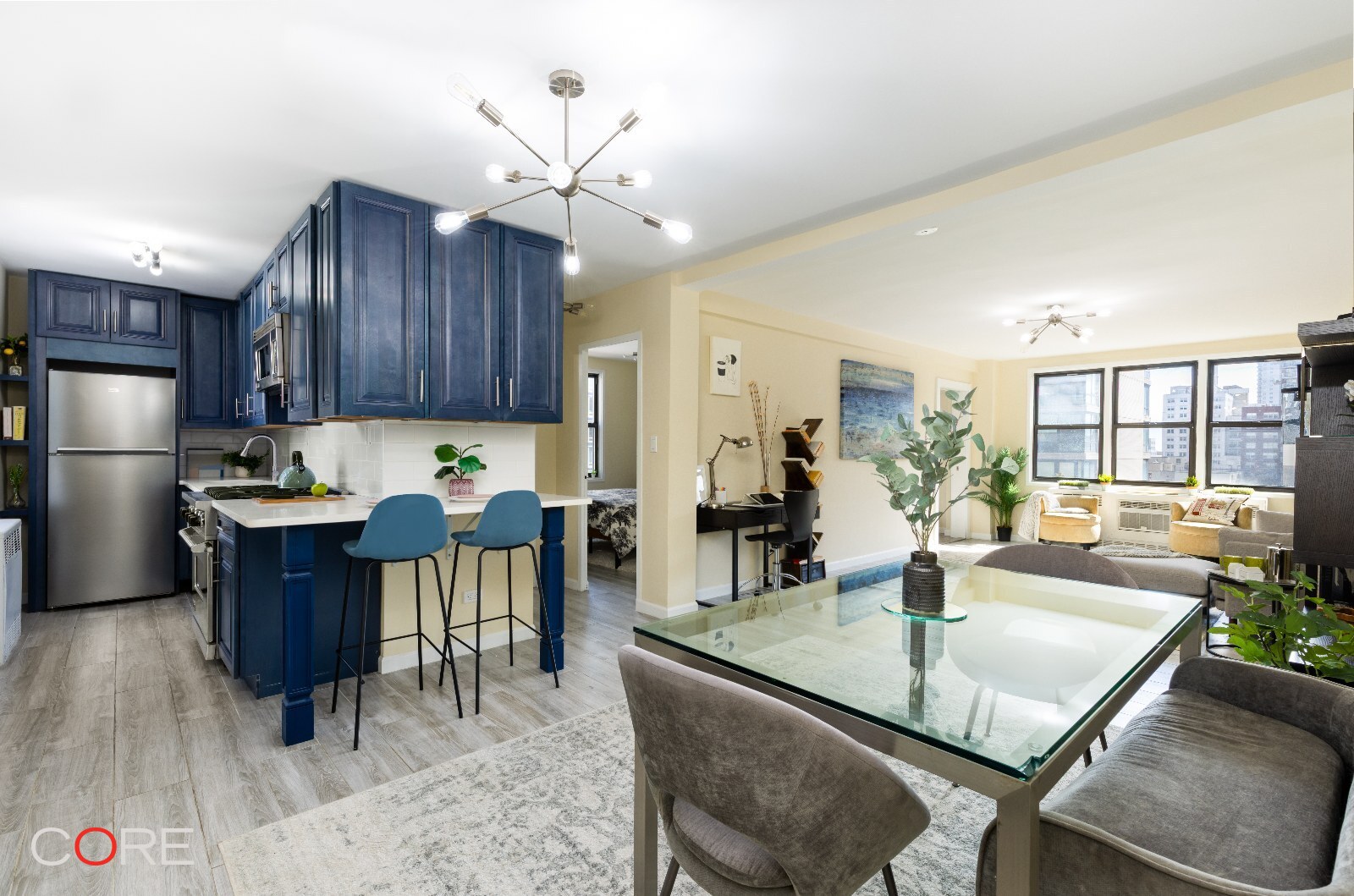 a kitchen with a dining table chairs and refrigerator