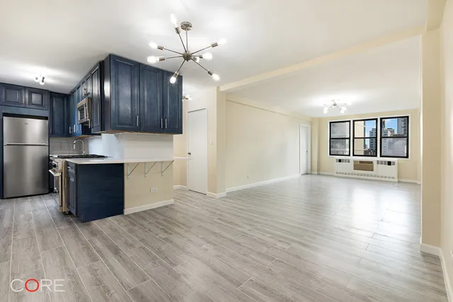 a view of kitchen with sink and wooden floor