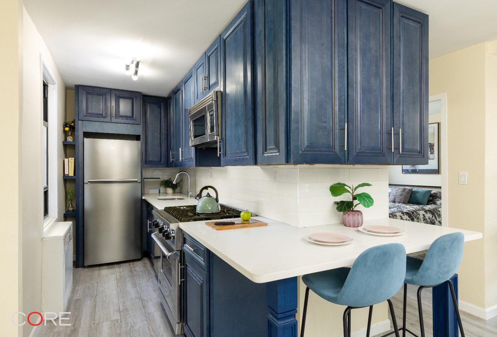 241 East 76th Street, Unit 9I Manhattan, NY 10021 - Photo 3 of 13 a kitchen with stainless steel appliances granite countertop a sink refrigerator and cabinets