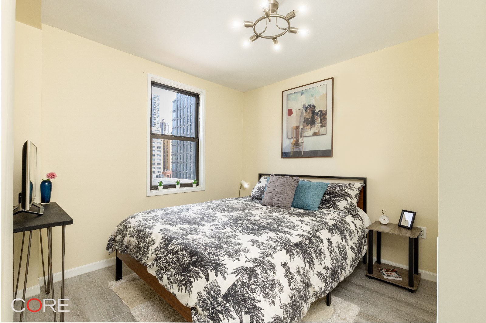 241 East 76th Street, Unit 9I Manhattan, NY 10021 - Photo 5 of 13 a bedroom with a bed and wooden floor
