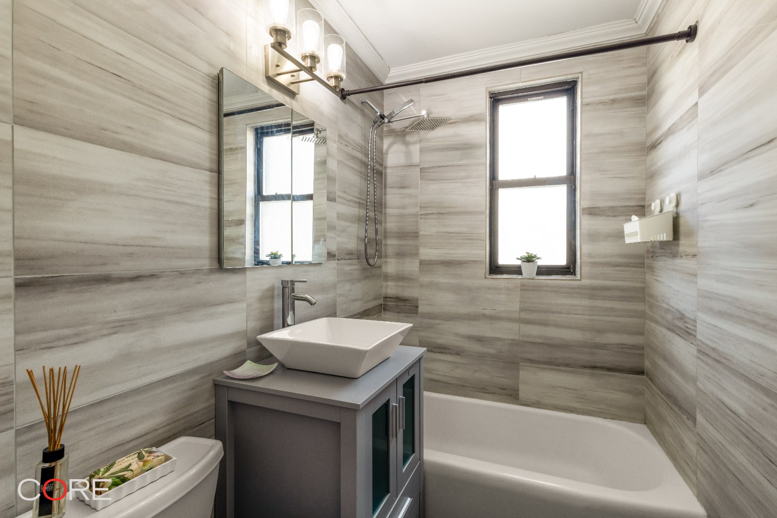 241 East 76th Street, Unit 9I Manhattan, NY 10021 - Photo 6 of 13 a bathroom with a sink a toilet and tub