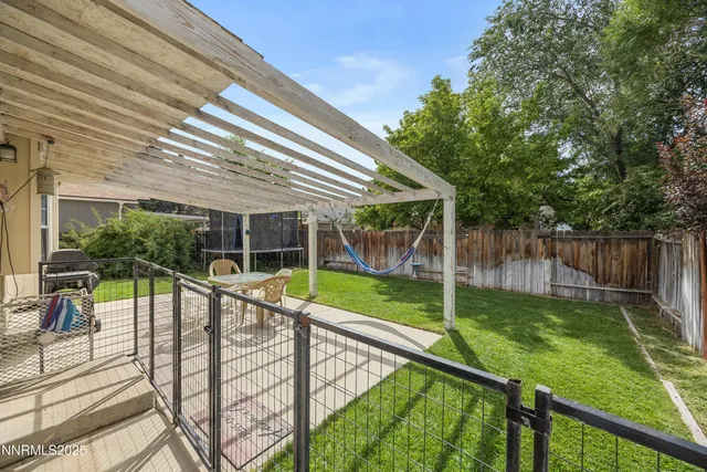 a view of a house with backyard and sitting area