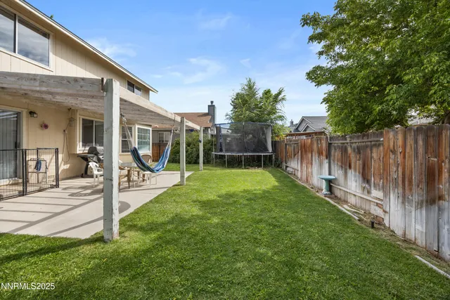 a view of a backyard with a patio and a garden