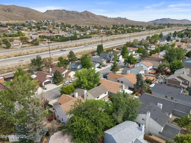 an aerial view of a house with a yard