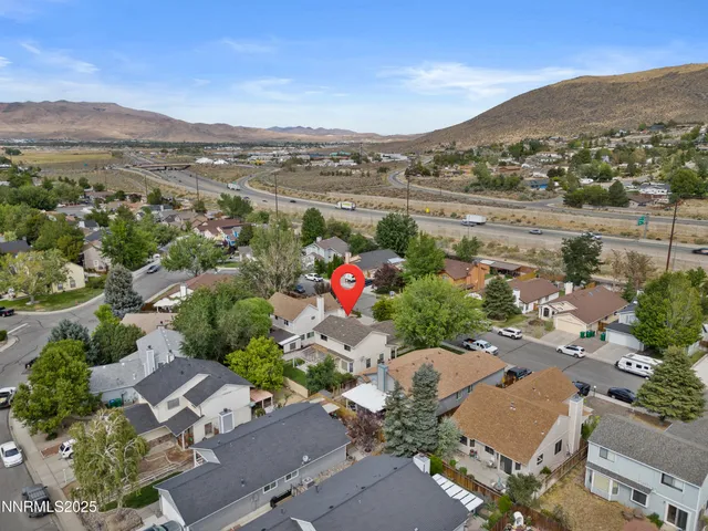 an aerial view of a houses with a road