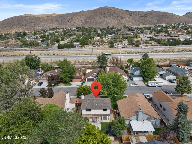 an aerial view of house yard and mountain view in back