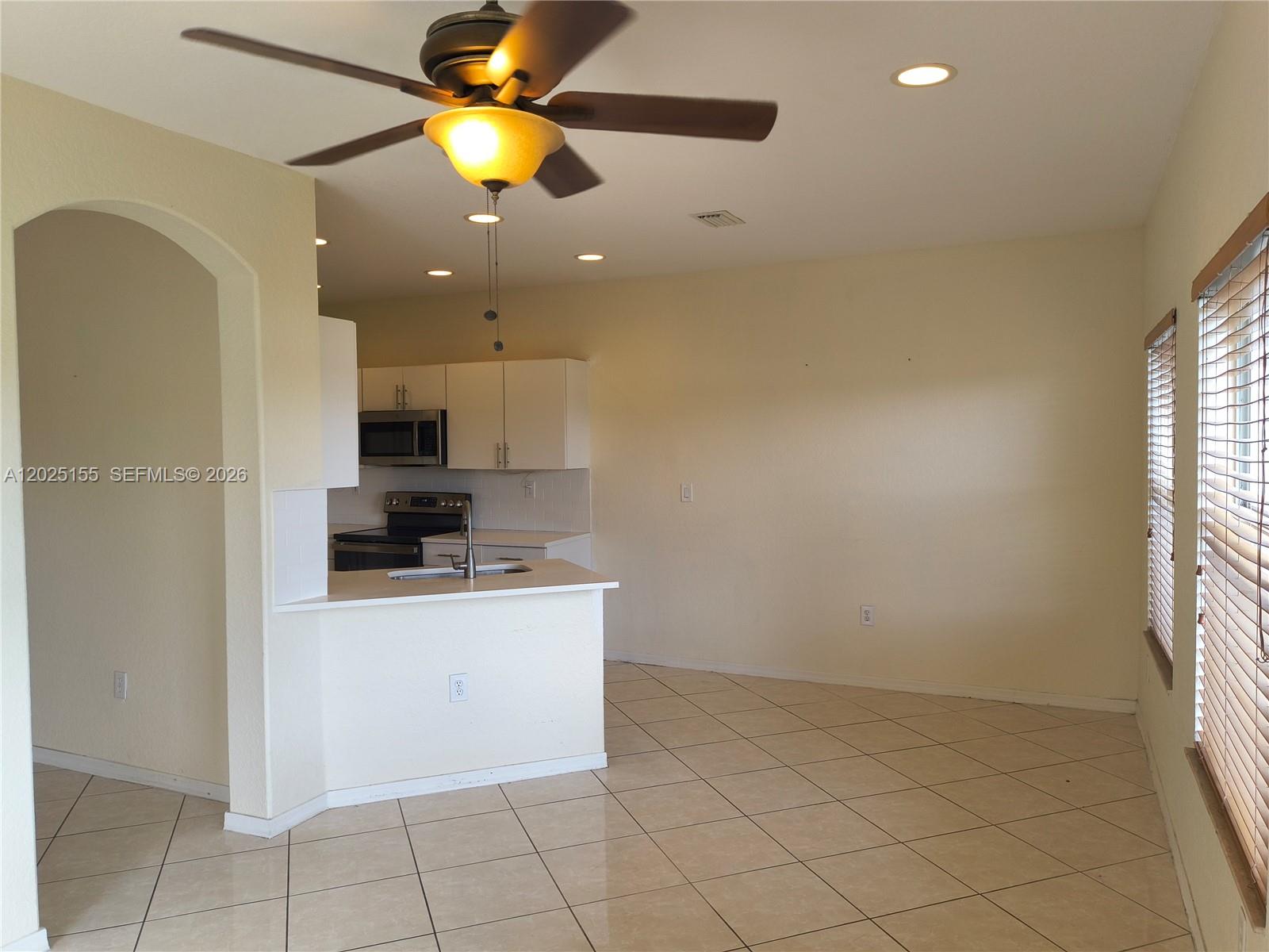 1645 Southeast 20th Road, Unit 1645 Homestead, FL 33035 - Photo 3 of 20 a kitchen with kitchen island granite countertop appliances cabinets and a sink