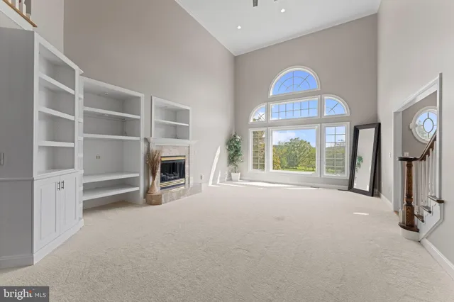 a bedroom with furniture and a large window