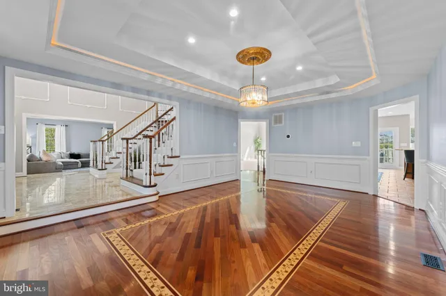 a living room with furniture a fireplace and a floor to ceiling window
