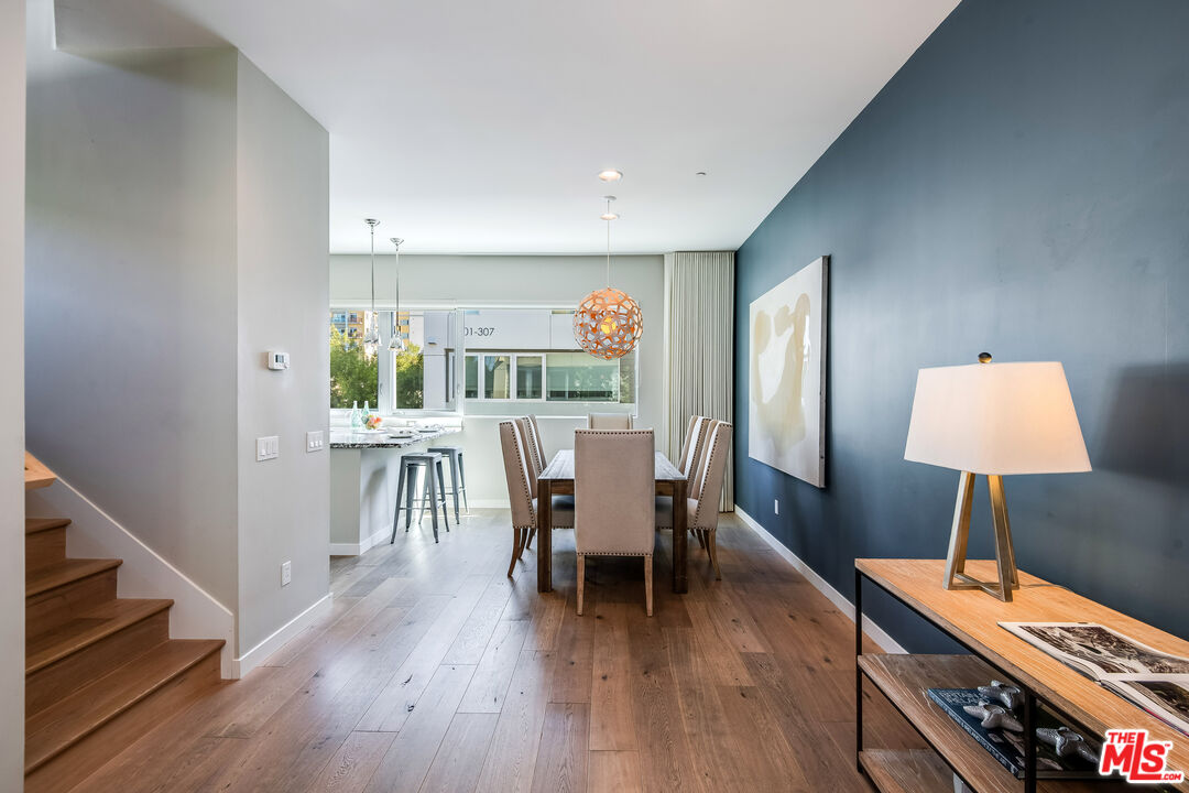 310 Washington Boulevard, Unit 401 Marina del Rey, CA 90292 - Photo 16 of 32 a dining room with furniture and wooden floor
