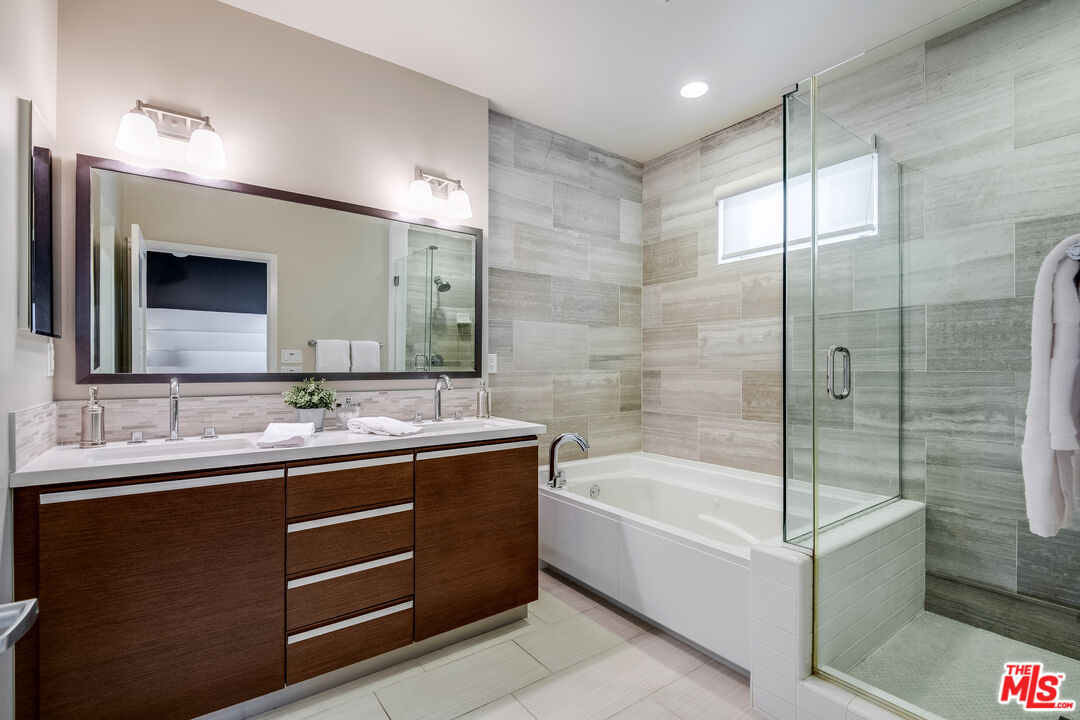 310 Washington Boulevard, Unit 401 Marina del Rey, CA 90292 - Photo 19 of 32 a bathroom with a bathtub a double vanity sink and mirror