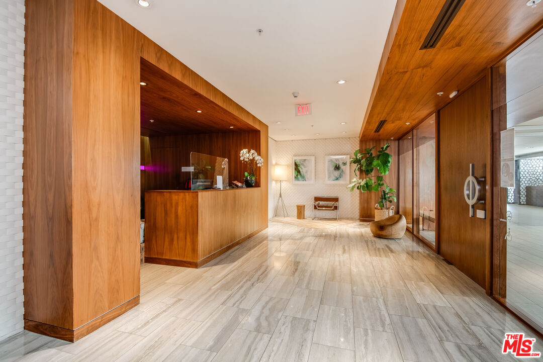 310 Washington Boulevard, Unit 401 Marina del Rey, CA 90292 - Photo 27 of 32 a view of a hallway with wooden floor and a living room