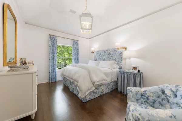 a spacious bedroom with a bed and a chandelier
