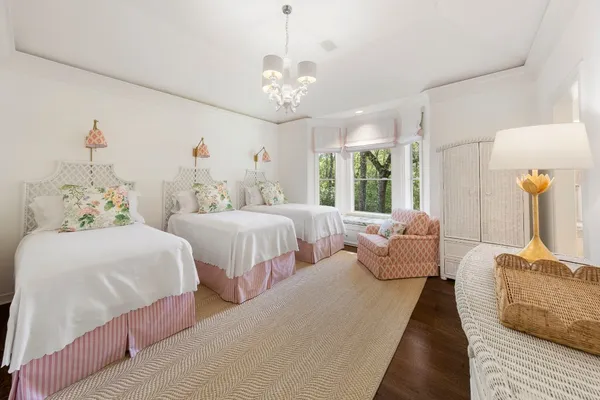 a bedroom with two beds and a chandelier