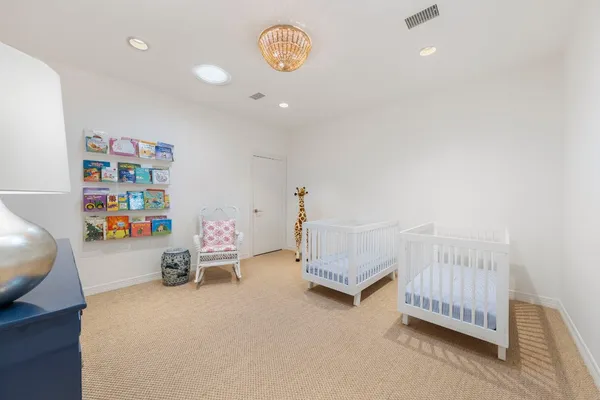 a bedroom with furniture and a baby crib
